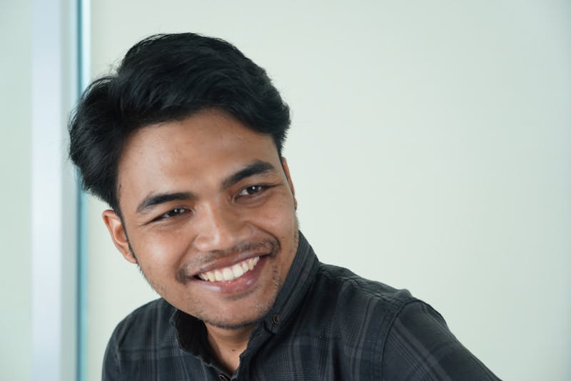 Head pizzaiolo crafting a pizza at the oven